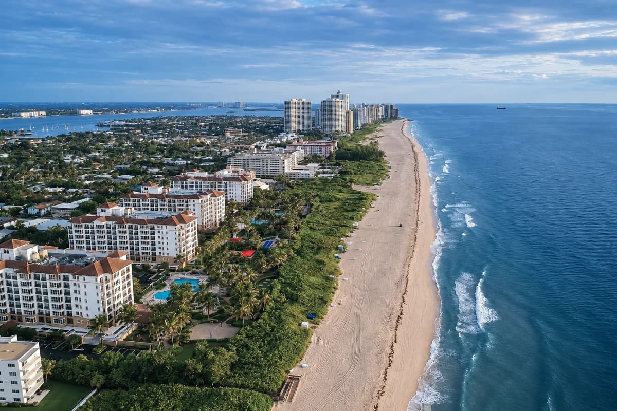Aerial view of the Palm Beach County coastline, with beachfront buildings and blue Atlantic water