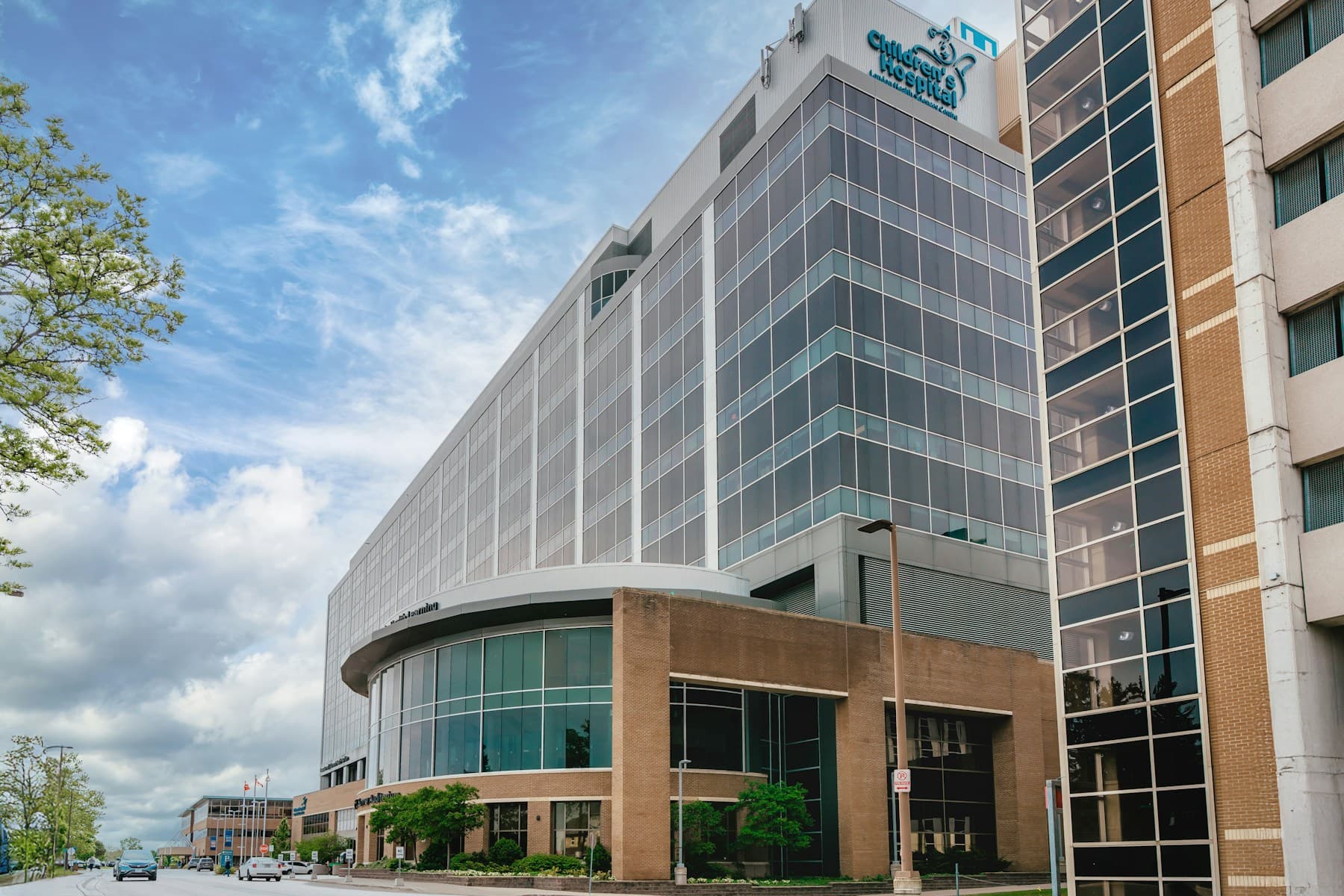 Representative hospital exterior with a modern glass facade and covered entrance